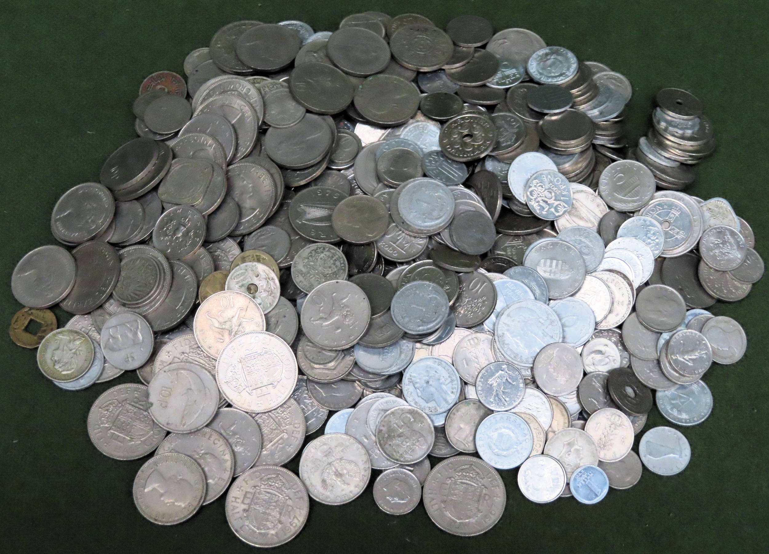 Large quantity of mostly foreign silver coloured coinage all used unchecked