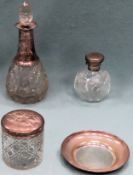 Silver topped pin jar, silver topped scent bottle, silver stemmed decanter, plus silver dish.