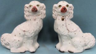 Pair of handpainted and gilded antique staffordshire spaniels. Approx. 32cm H