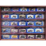 Glazed display case containing boxed die cast vehicles all used appear reasonable