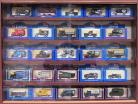 Glazed display case containing boxed die cast vehicles all used appear reasonable