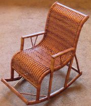 Vintage child's/doll's wicker rocking chair. Approx. 55cms H reasonable used condition. damage to