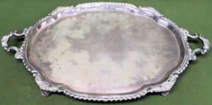 Large silver plated repousse decorated two handled serving tray on raised supports by S H & Co.