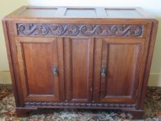 Early 20th century panelled oak small carved sideboard. Approx. 85cm H x 105cm W x 44cm D Used
