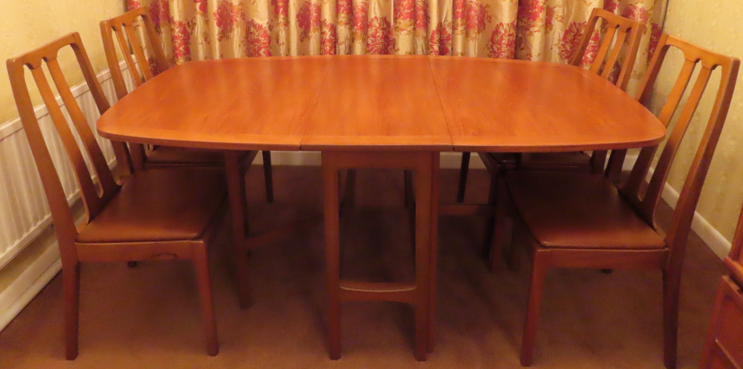 Nathan mid 20th century teak gateleg dining table with four chairs. Table Approx. 75 x 176 x 99cms