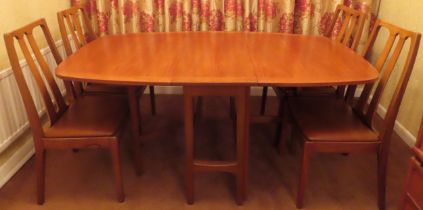 Nathan mid 20th century teak gateleg dining table with four chairs. Table Approx. 75 x 176 x 99cms