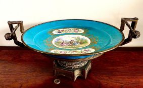 HAND DECORATED AND GILDED PLAQUE/SHALLOW BOWL, CONTAINED AND RAISED WITHIN A GILDED METAL STAND,