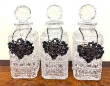 THREE CUT GLASS DECANTERS, APPROX 22.5cm HIGH, PLUS THREE SILVER LABELS, SHEFFIELD 1843