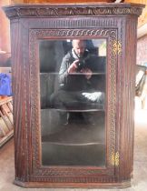 20th century carved fronted oak single door glazed wall mounting corner cabinet. Approx. 103cm H x