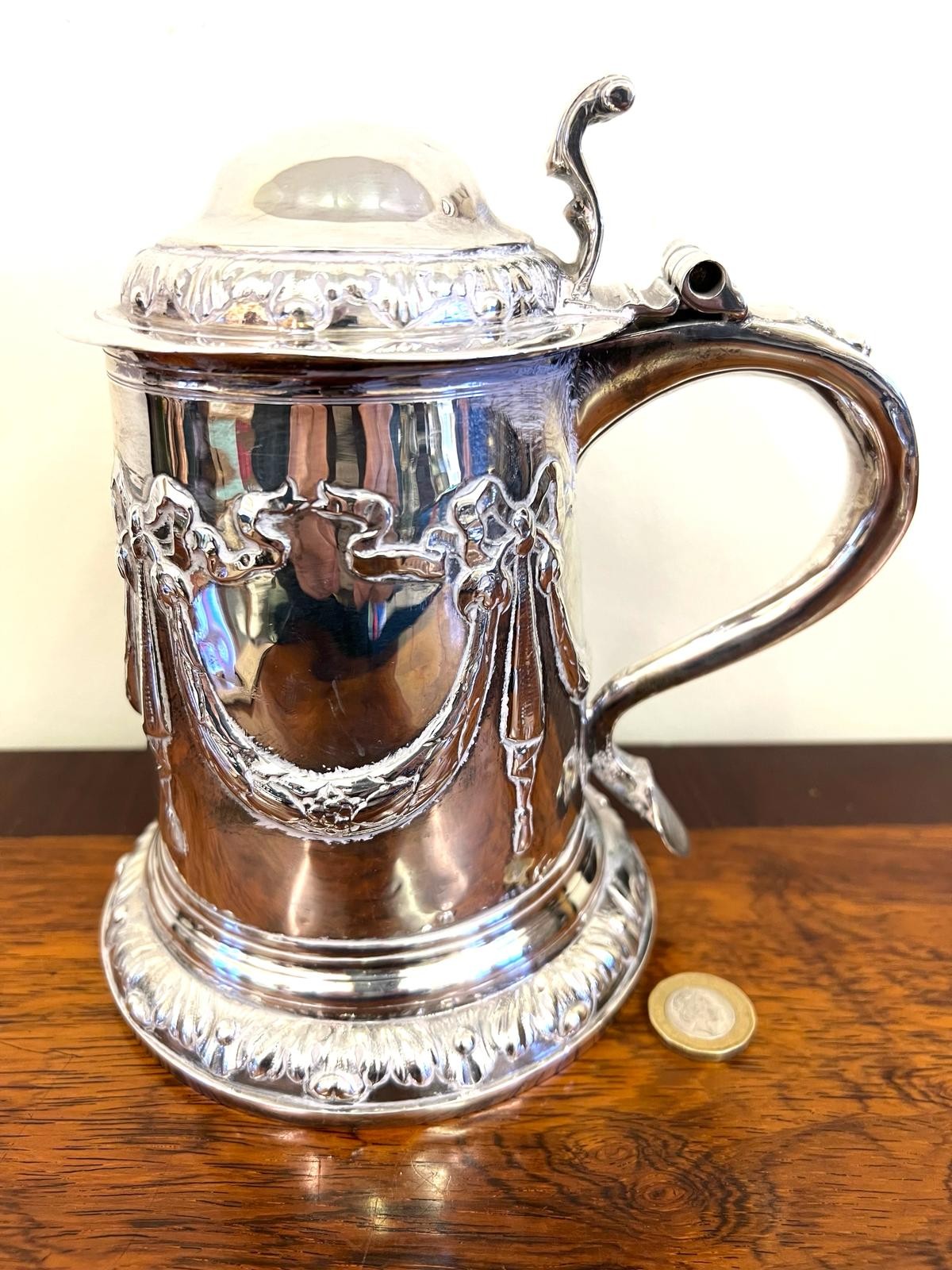 SILVER TANKARD WITH SCROLLED HANDLE AND HINGE COVER, REPOUSSE SWAG DECORATION, APPROX 18cm HIGH
