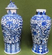 Pair of similar late 19th/early 20th century blue and white ceramic vases, one with cover, decorated