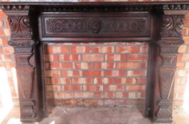 Carved oak fire surround. Approx. 114cm H x 160cm W x 28cm D Used condition, damage to areas,
