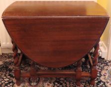 Oak barley twist gateleg table. Approx. 74cm H x 150cm W x 92cm D