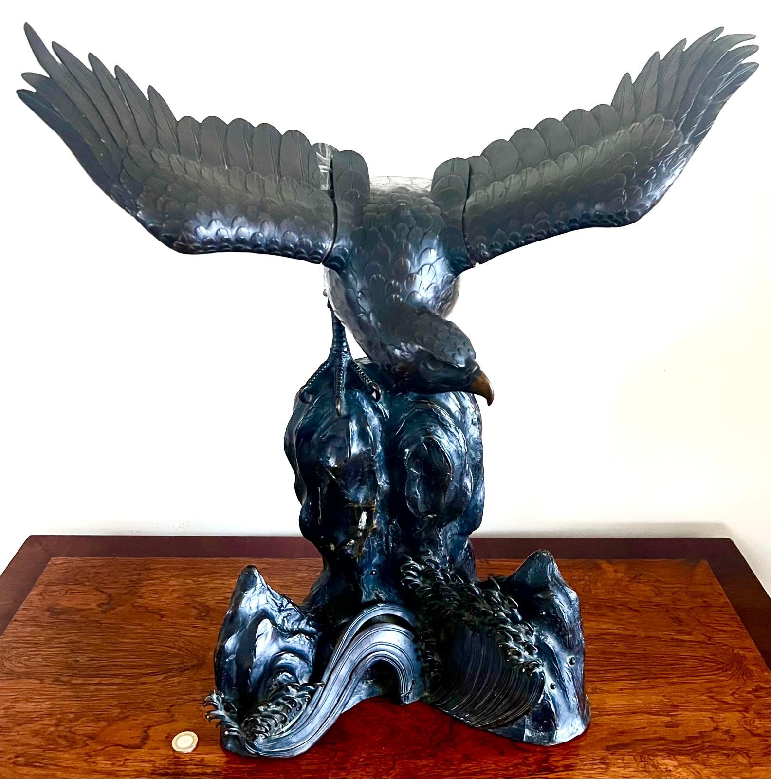 19TH CENTURY IMPRESSIVE JAPANESE BRONZE EAGLE CENSER ON BRONZE ROCKS AMIDST STYLISTIC BREAKING WAVE