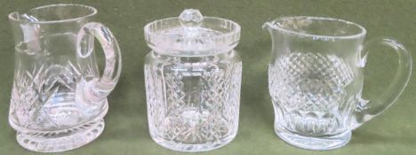 Waterford crystal jug, another glass jug, plus glass biscuit barrel with cover