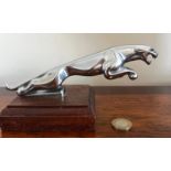 LEAPING JAGUAR CAR MASCOT UPON WOODEN STAND, APPROX 20cm IN LENGTH