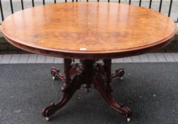 19th century inlaid and figured walnut veneered tilt top oval breakfast table on quadraoil supports.