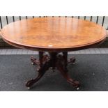 19th century inlaid and figured walnut veneered tilt top oval breakfast table on quadraoil supports.