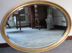 20th century oval and bevelled wall mirror. Approx. 56 x 76cm