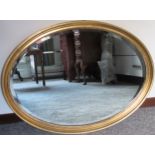 20th century oval and bevelled wall mirror. Approx. 56 x 76cm