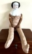 1860s DOLL WITH PORCELAIN HEAD AND SHOULDERS, FABRIC BODY AND LEATHER FOREARMS AND HANDS