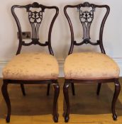 Pair of Edwardian piercework decorated carved mahogany bedroom chairs. Approx. 92cm H