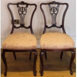 Pair of Edwardian piercework decorated carved mahogany bedroom chairs. Approx. 92cm H