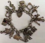 Hallmarked silver charm bracelet with various charms. Total Weight Approx. 55.4g