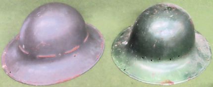Two vintage Military helmets Both in used condition, dent to the top of one helmet