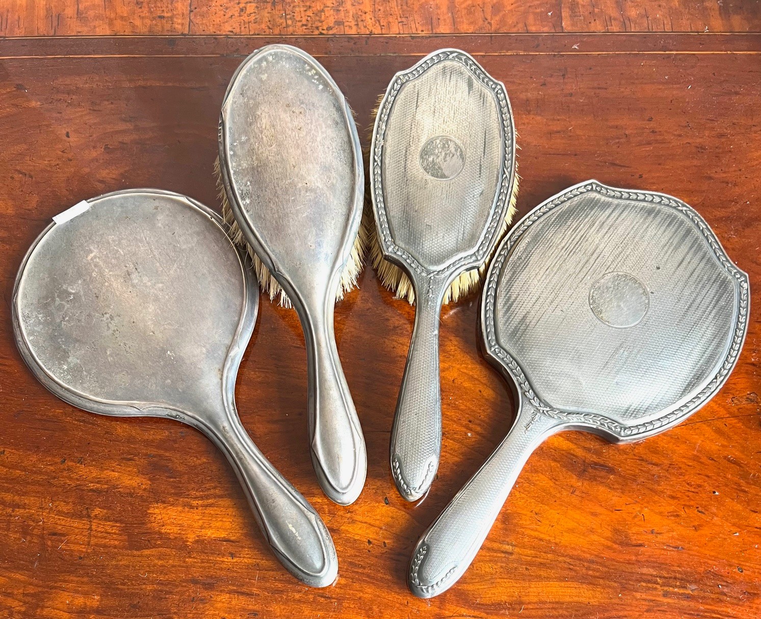 FOUR SILVER DRESSING TABLE PIECES- TWO MIRRORS AND TWO BRUSHES, VARIOUS ASSAYS INCLUDING CHESTER AND