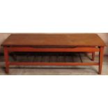 1970's teak coffee table on stretchered supports. Approx. 37cm H x 115cm W x 45cm D Used