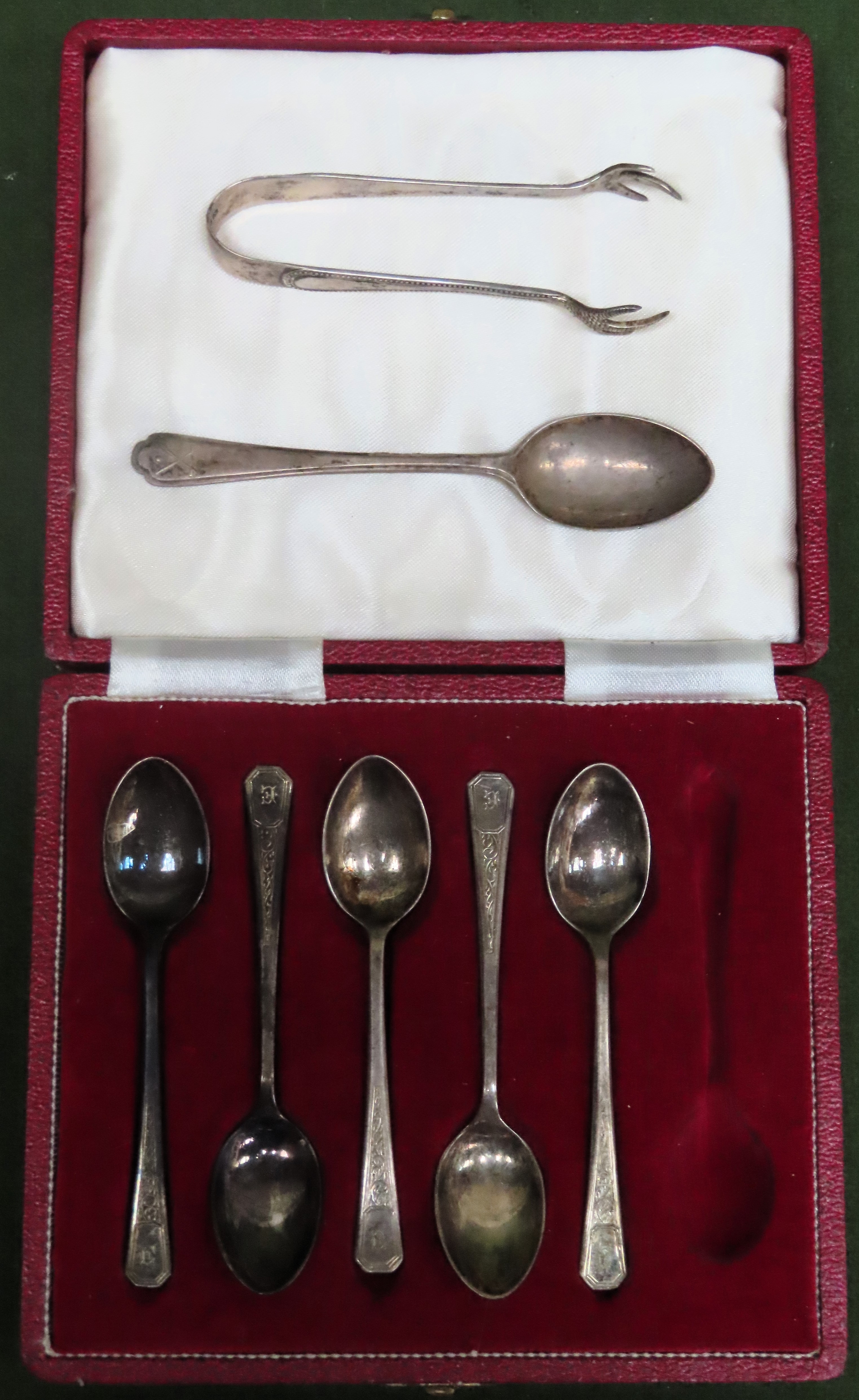 Casd set of 5 hallmarked silver coffee spoons, another silver teaspoon, plus silver sugar tongs.