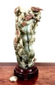 LATE 20th CENTURY JADE CARVING OF A DOG AT BASE OF A TREE ENTWINED WITH VINE LEAVES AND ALIGHTED