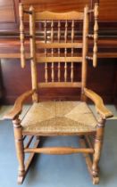 Early 19th century rush seated country style oak spindle back rocking chair. Approx. 120cm H