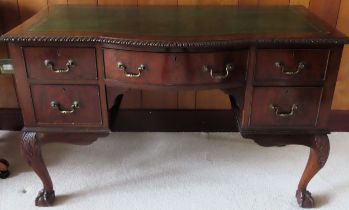Early 20th century mahogany pie crust edged five drawer writing desk with leather fitted insert