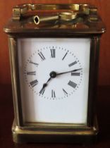 Early 20th century brass and glass carriage clock with enamelled dial. Approx. 11cms H reasonable