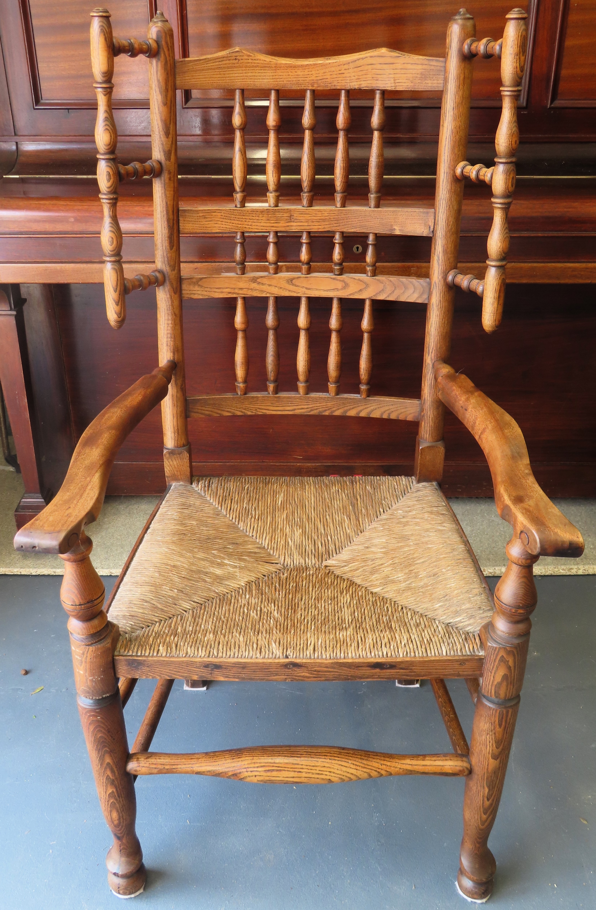 Early 19th century rush seated country style oak spindle back armchair. Approx. 115cm H Reasonable