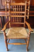 Early 19th century rush seated country style oak spindle back armchair. Approx. 115cm H Reasonable