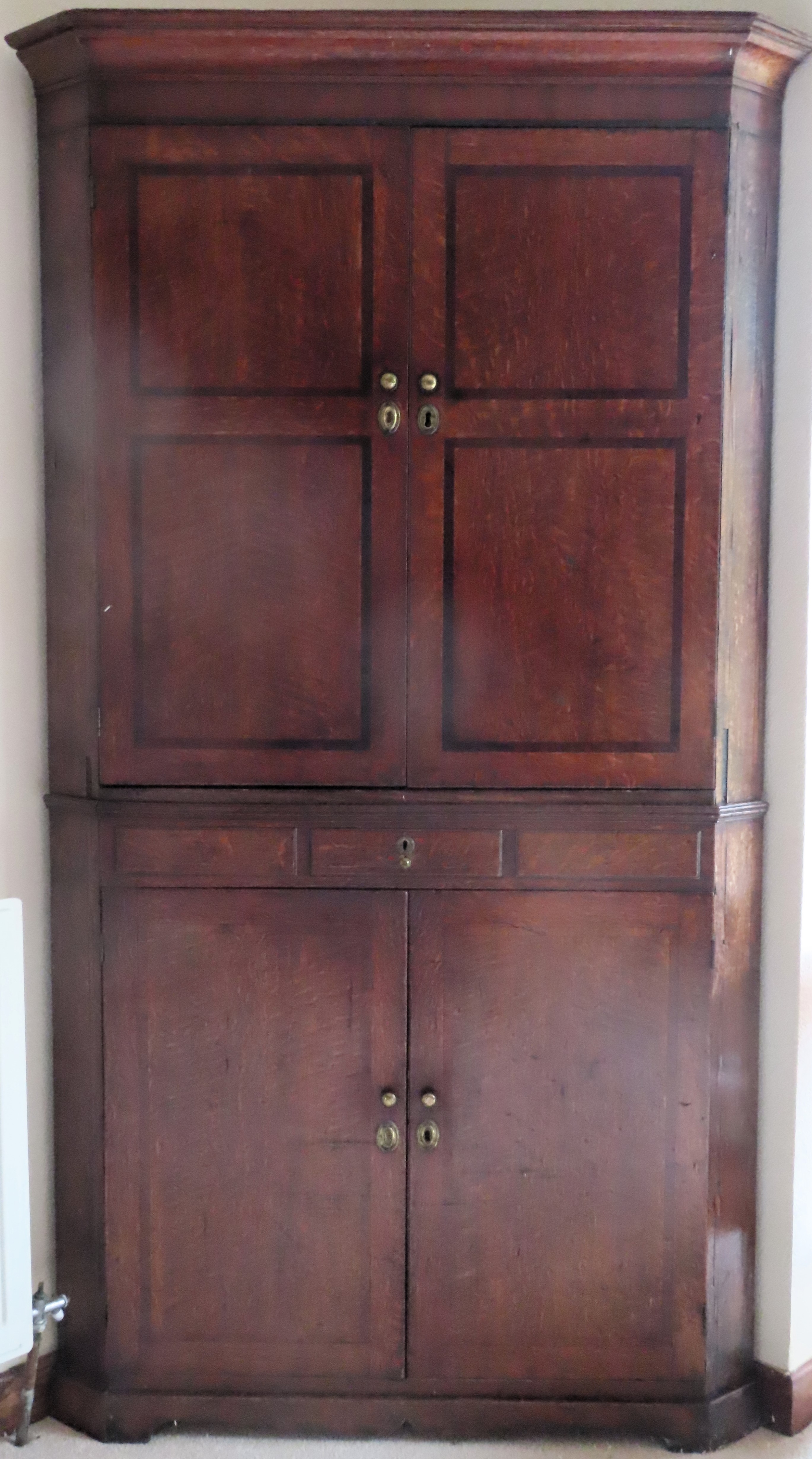 19th century large panelled oak four door corner cupboard with single drawer. Approx. 187 x 98 x