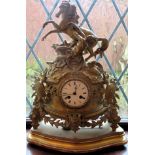 French style gilt metal and ornately decorated mantle clock, on gilded stand used not tested dial