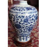 Large Oriental style blue and white glazed ceramic vase, on piercework wooden stand. Approx. 41cm