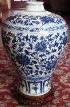 Large Oriental style blue and white glazed ceramic vase, on piercework wooden stand. Approx. 41cm