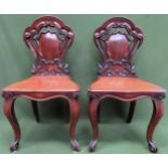 Pair of Victorian carved and piercework decorated mahogany shield back hall chairs. Approx. 85 x