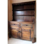 Early 20th century linenfold fronted oak kitchen dresser with plate rack. Approx. 173 x 122 x