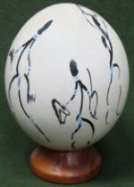 Ostrich egg with handpainted African style decoration on stand. Approx. 19.5cm Used condition,