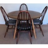 Ercol mid 20th century oak drop leaf dining table with four stick back chairs. Tbale Approx. 70 x