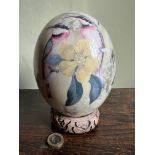 DECORATED OSTRICH EGG ON WOODEN STAND