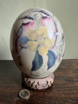 DECORATED OSTRICH EGG ON WOODEN STAND