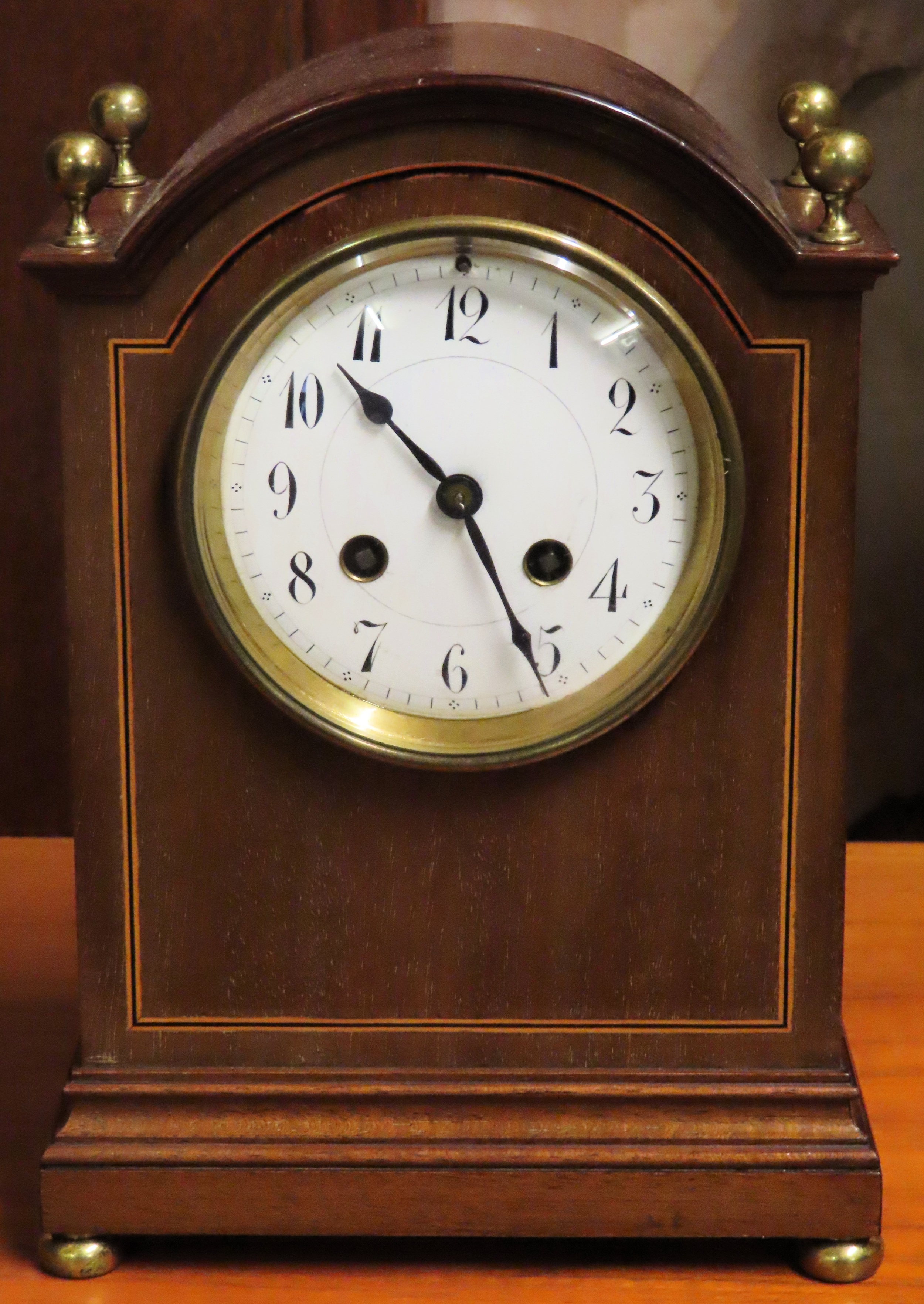 Inlaid mahogany mantle clock with circular enamelled dial. Approx. 36cm H Used condition, not tested