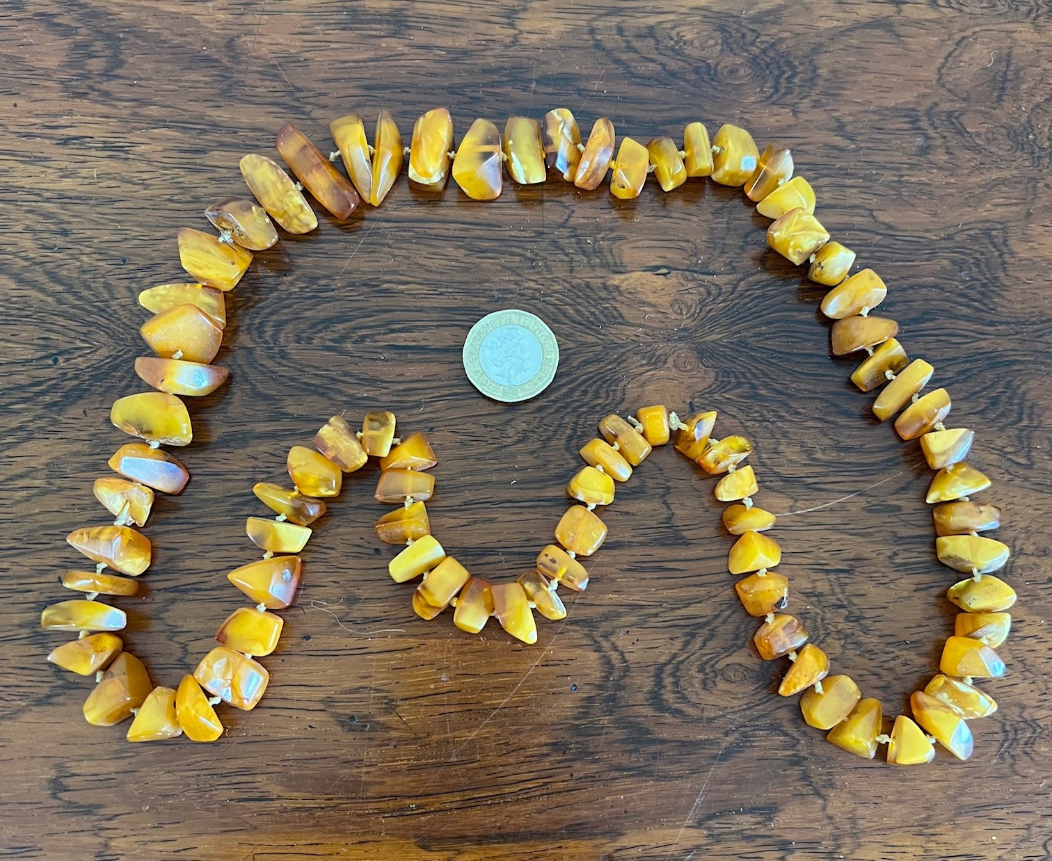 STRING OF OPAQUE AND CLEAR AMBER PIECES TO FORM A NECKLACE, INDIVIDUAL KNOTTED, APPROX 39cm